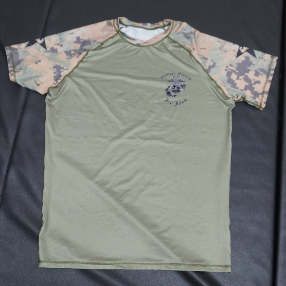 Green Marine Corps camo jiu jitsu rash guard, flat-lay photo
