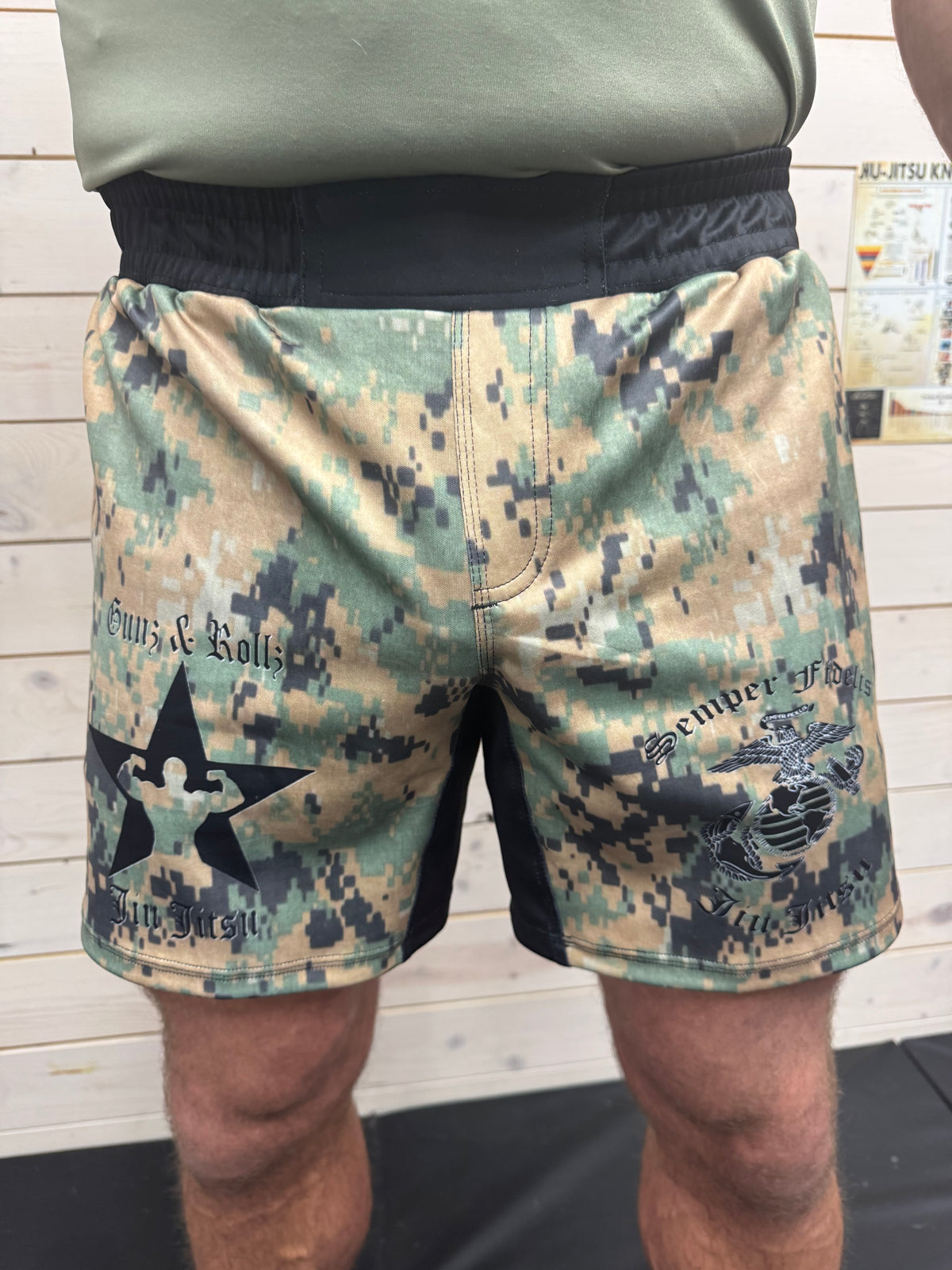 Model wearing Marine Corps camo jiu jitsu shorts, front view